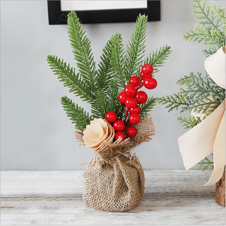 Artificial Christmas Tree Decorations featuring jute wrapping, red berries, and pine cones